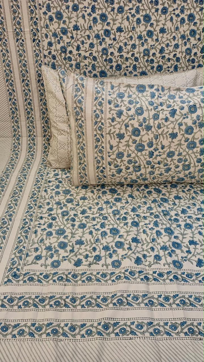 Neelam hand block Percale Cotton bedsheet with an all-over blue floral print on the sheet and pillow covers