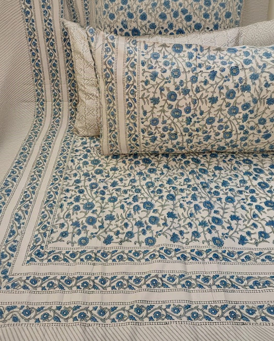 Neelam hand block Percale Cotton bedsheet with an all-over blue floral print on the sheet and pillow covers