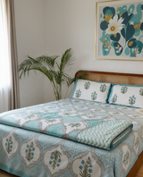 Pastel green Mughal ogee bedding set with bedsheet, pillow covers and dohar folded on a bed