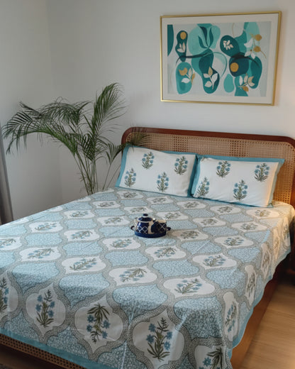 Pastel green Mughal ogee cotton bedsheet and pillow covers styled with a blue teapot
