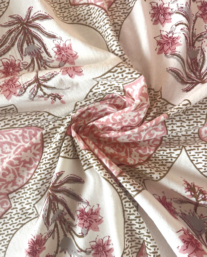 Close-up of blush pink Mughal ogee cotton fabric with a floral spray medallion