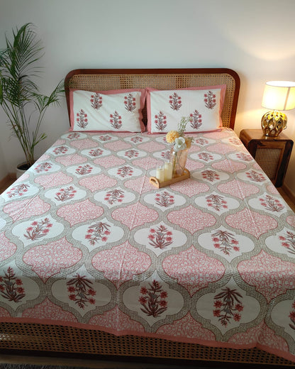 Blush pink Mughal ogee motif cotton bedsheet on white with a pink border