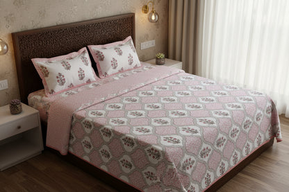 Blush pink Mughal ogee cotton bedsheet styled on a dark carved wood bed