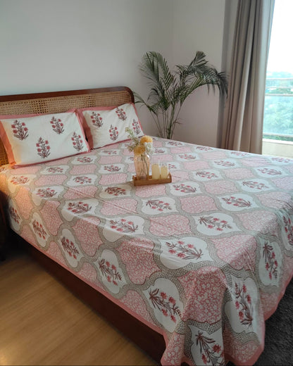 Blush pink Mughal ogee cotton bedsheet on a bed styled from the right angle