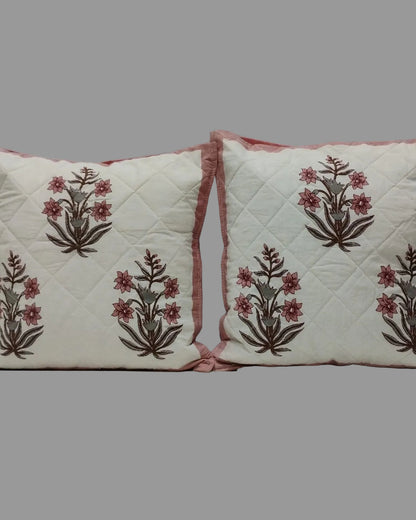 Pair of Neerja pink quilted cushion covers with repeating pink floral motifs