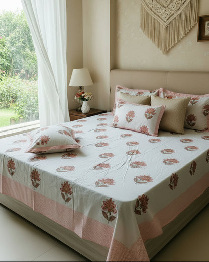 Noor orange floral pure cotton bedsheet – styled on a bed