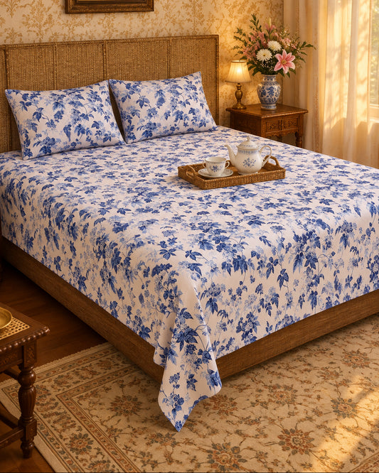 Pallav Blue indigo floral bedsheet with a tea tray on a cane-headboard bed