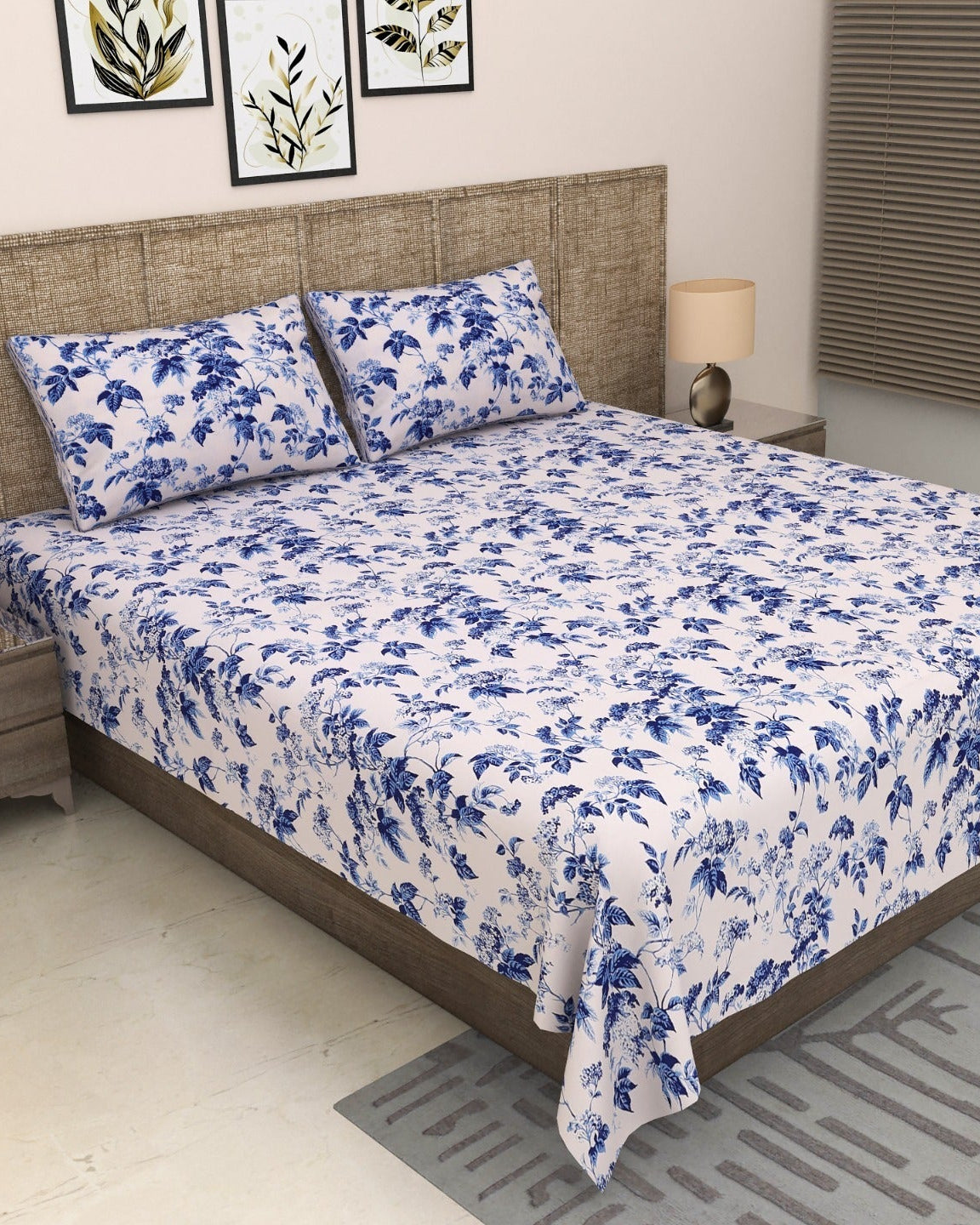 Pallav Blue indigo floral bedsheet and pillow covers on a grey upholstered bed