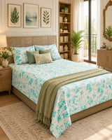 Pallav Light Blue Everyday Cotton bedsheet with aqua florals on white, styled with sage cushions and a green throw