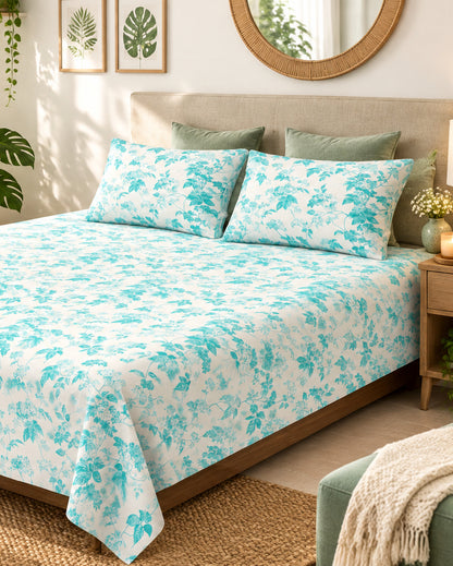Pallav Light Blue floral bedsheet and pillow covers on a bed with a light headboard