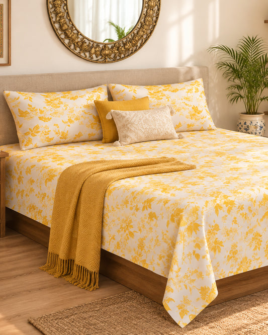 Pallav Yellow Everyday Cotton bedsheet with mustard-yellow florals on white, styled with a mustard throw
