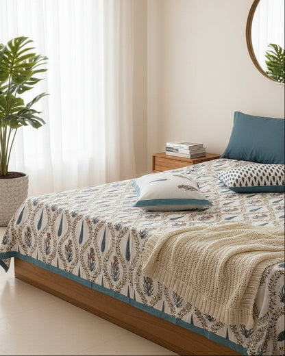 Pallavi blue leaf pure cotton bedsheet – styled on a bed