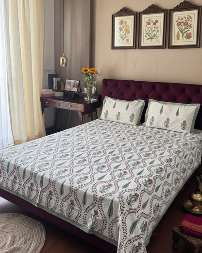 Pallavi green leaf pure cotton bedsheet – styled on a bed