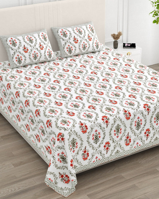 Parijat Orange bedsheet, white floral ogee jaal with coral-orange flowers, in a studio shot against a cream headboard