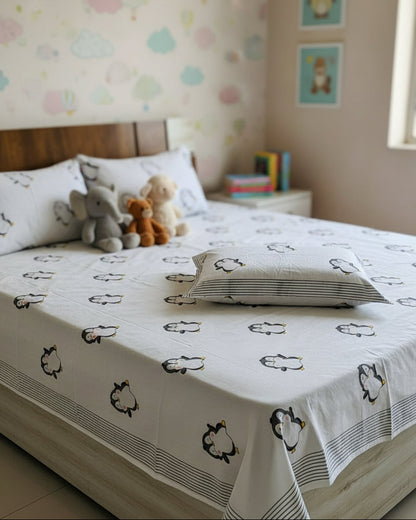 Pingu black hand block pure cotton kids bedsheet – styled on a bed