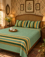 Preet Green striped bedsheet and pillow covers with a tea tray on a cane-headboard bed