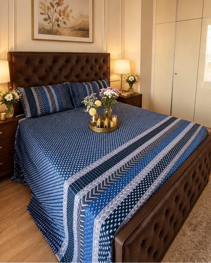 Preet Blue dotted navy bedsheet with stripe bands on a dark wooden bed