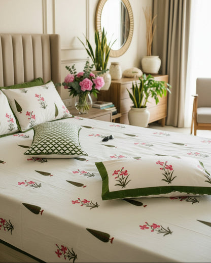 Pushpita Green Everyday Cotton bedsheet – pink orchid florals and green motifs on a beige bed
