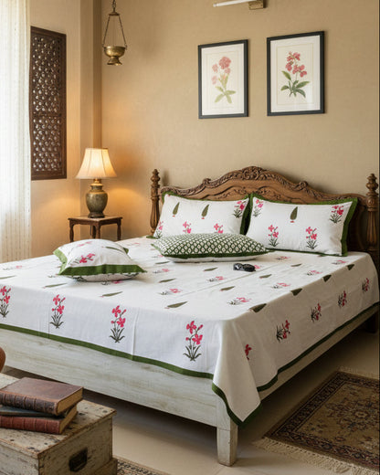 Pushpita pink orchid cotton bedsheet with a green border in a traditional bedroom
