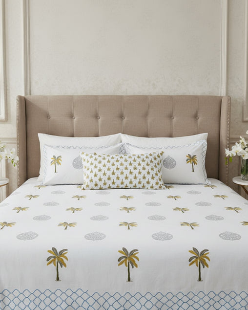 Bedding set with palm tree and leaf patterns on a white background
