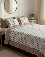 Close-up of ivory cotton fabric with coral orange floral booti and a coral border