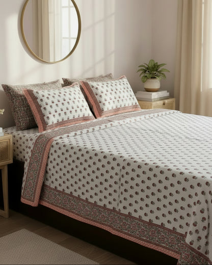 Close-up of ivory cotton fabric with coral orange floral booti and a coral border