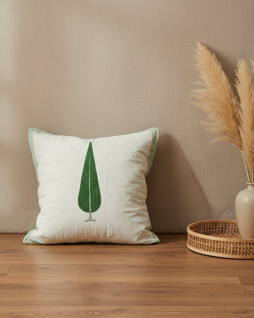 Suparna green quilted cushion cover styled with a single green cypress tree motif