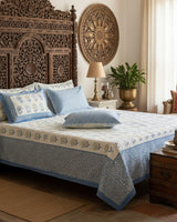 Surajmukhi blue floral pure cotton bedsheet – styled on a bed