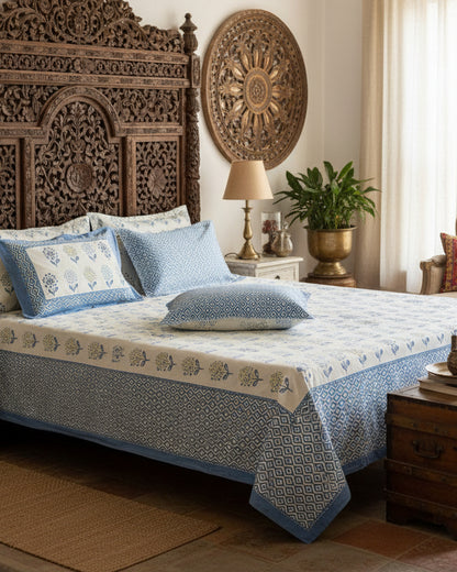 Surajmukhi blue floral pure cotton bedsheet – styled on a bed