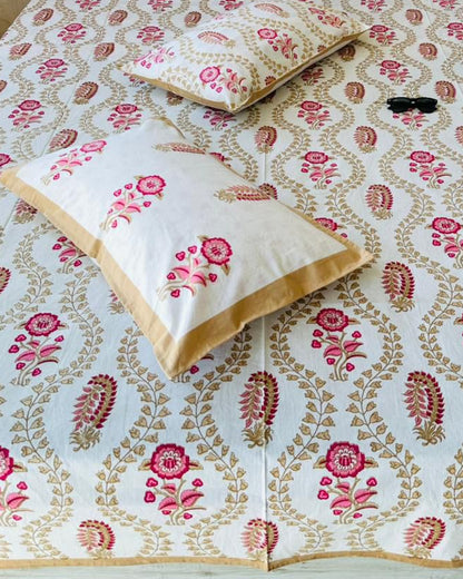 Close-up of tan trellis cotton fabric with pink florals and reversible pillow covers