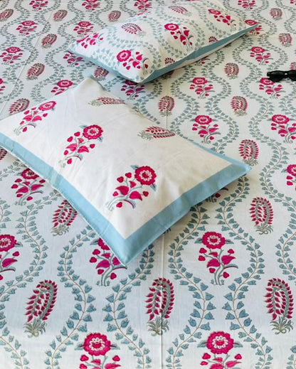 Close-up of sage trellis cotton fabric with magenta florals and reversible pillow covers