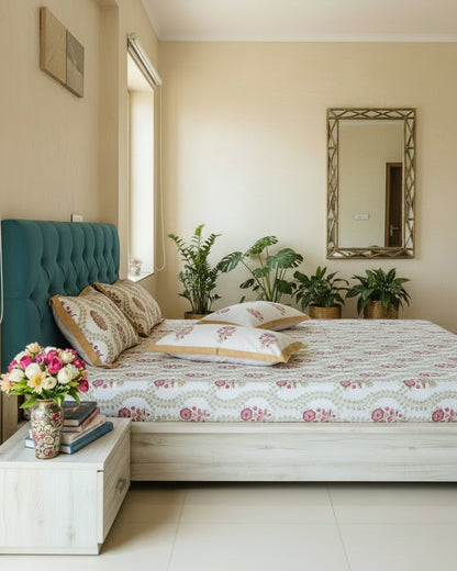 Tan trellis floral cotton bedsheet styled on a teal headboard bed with fresh flowers