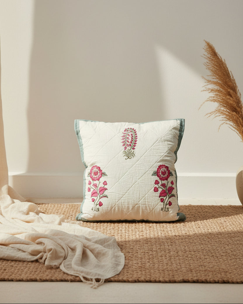 Surmayi blue quilted cushion cover styled with pink flowers and teal trim
