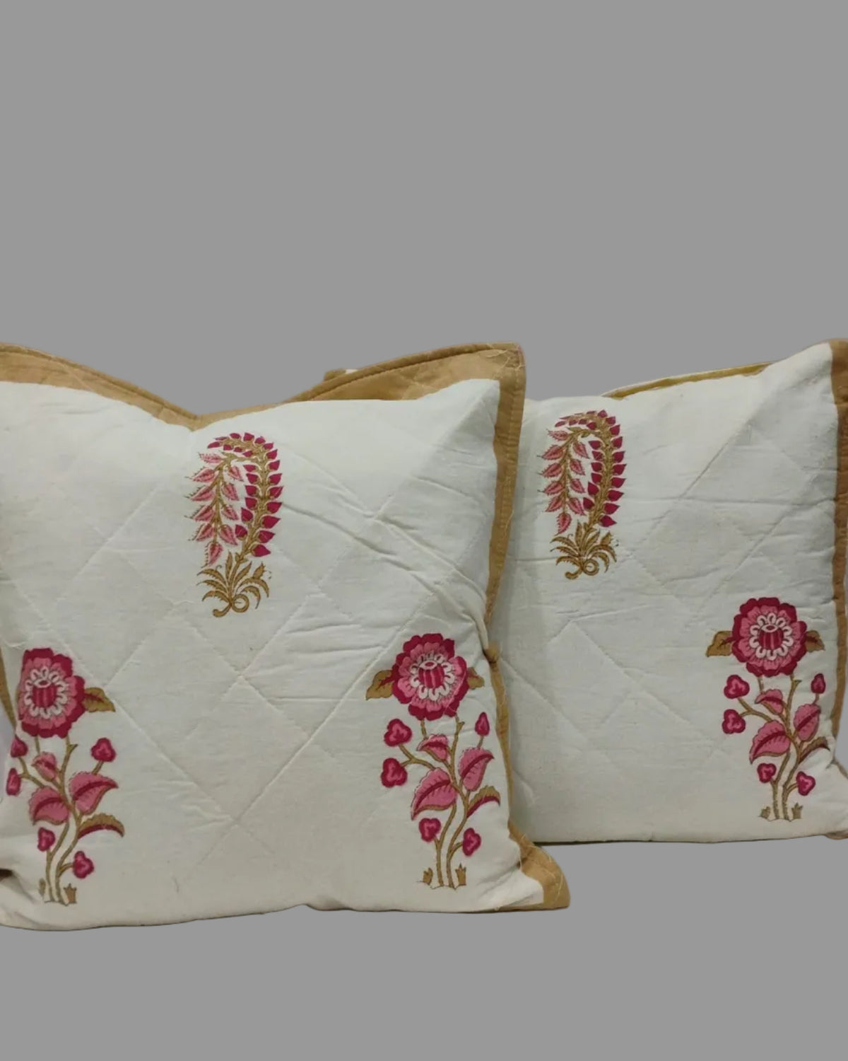 Pair of Surmayi cushion covers with pink floral and paisley motifs and mustard trim