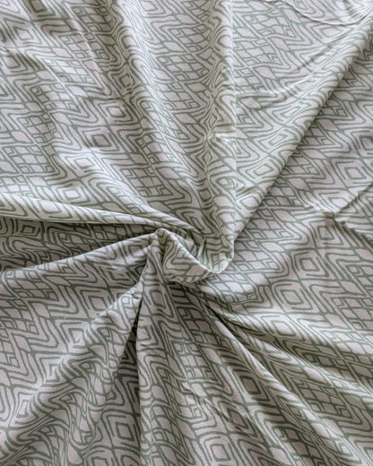 Close-up of patterned bedsheet cotton fabric with geometric design in green