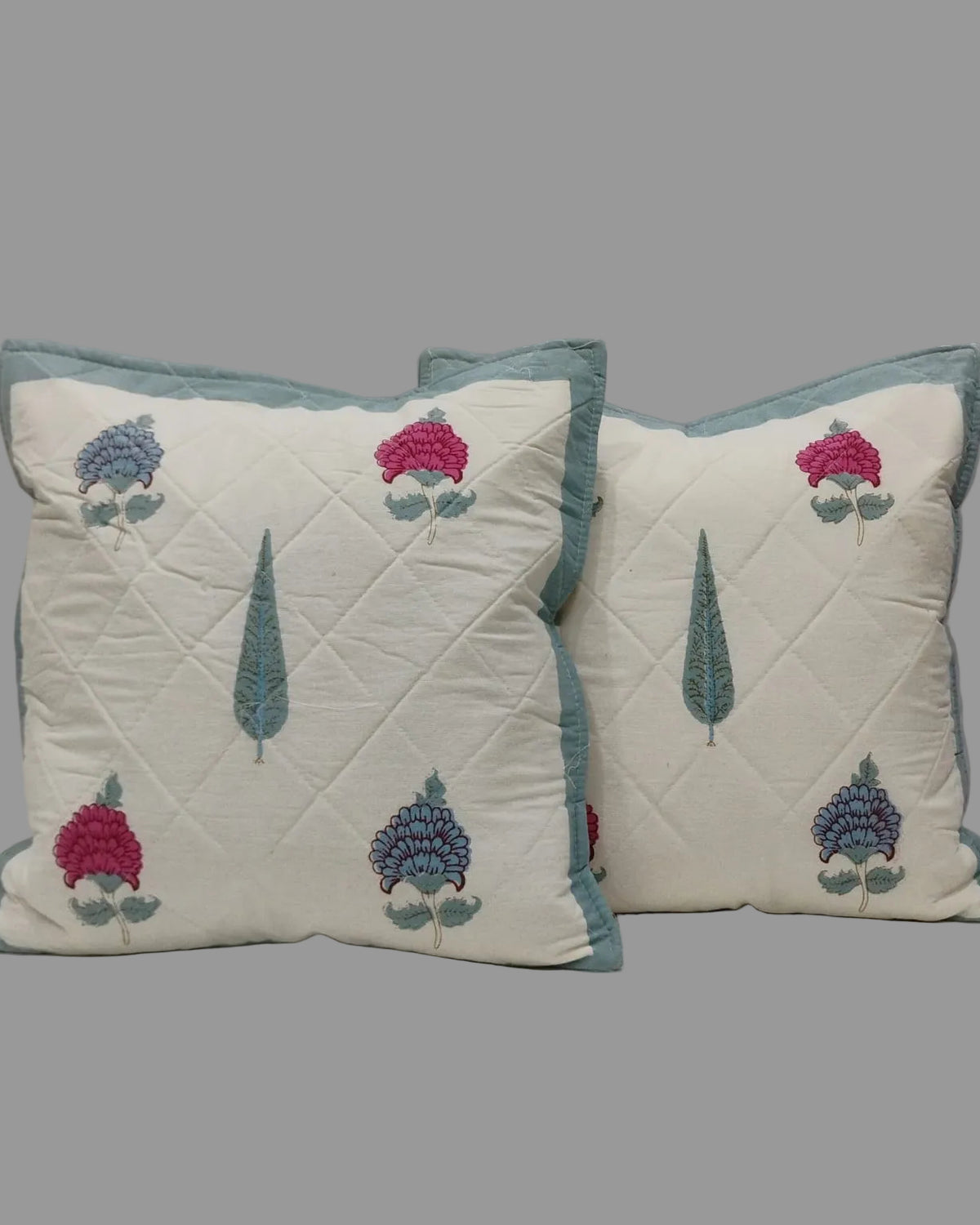 Pair of Tarangini blue quilted cushion covers with pink and blue flowers and teal tree motifs