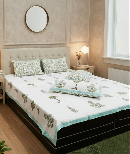 Sage green leaf motif soft fine cotton bedsheet styled with fresh flowers and a mirror