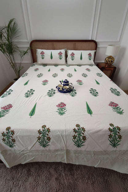 Pink and mustard floral booti cotton bedsheet with olive cypress leaves and an olive border