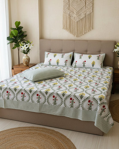 Vasundhara green red floral pure cotton bedsheet – styled on a bed