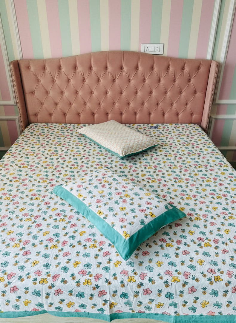 Bed with floral bedding and wooden headboard in a room.