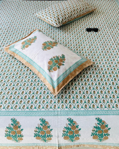 Close-up of teal jaal lattice cotton fabric with mustard gold florets
