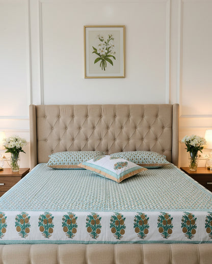 Teal jaal lattice cotton bedsheet with mustard gold floret border styled with fresh flowers