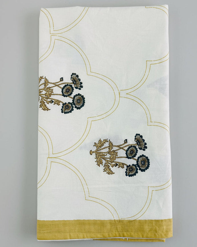Folded pink and olive floral booti cotton bedsheet with mustard scalloped detail